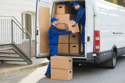 Man With Van Earlscourt pricing explained beside a moving van and packed boxes