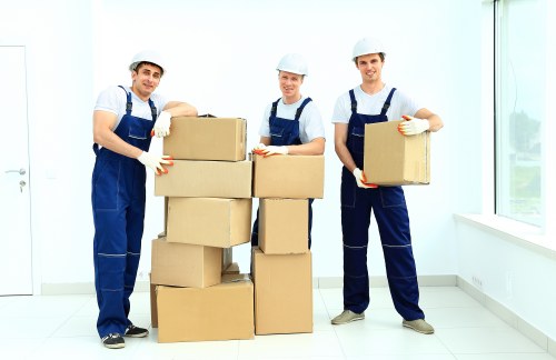 Movers handling furniture and boxes during a home move