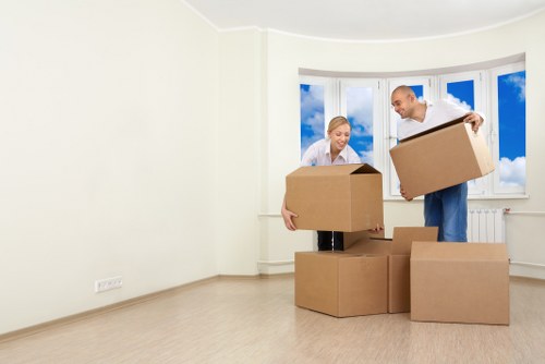 Moving boxes and furniture being loaded into a van